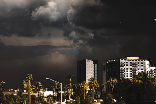 A city skyline under dark, stormy clouds creating a moody atmosphere.