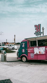 A vibrant vintage ice cream truck parked outdoors in downtown Dubai with a clear sky.