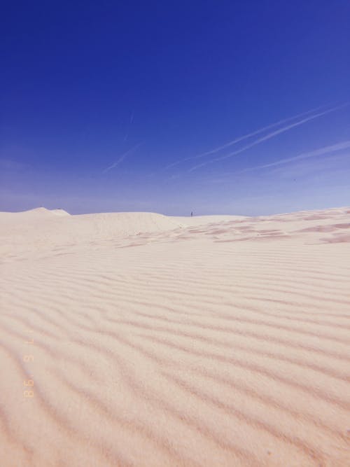 Low Angle Shot Of White Desert Sands Under Clear Blue Skies