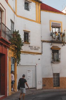 Explore the charming streets of Sevilla with traditional Andalusian architecture.