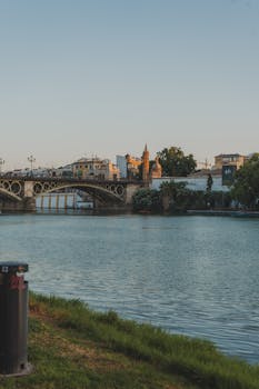 Beautiful view of Puente de Isabel II over the Guadalquivir River in Seville during sunset.