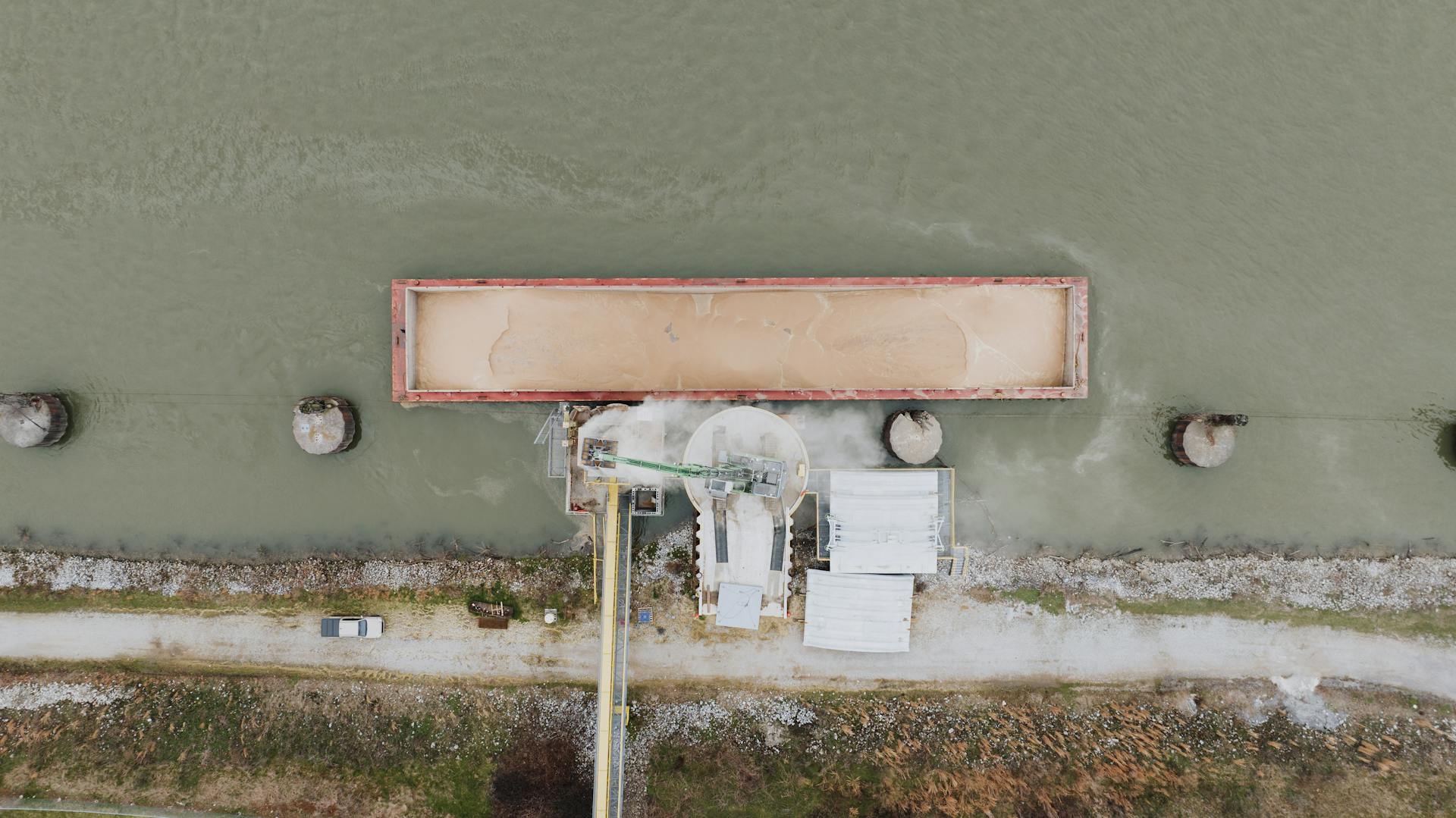 Aerial shot of an industrial barge loading operation on the river in Chattanooga.