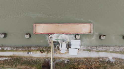 Free Aerial shot of an industrial barge loading operation on the river in Chattanooga. Stock Photo