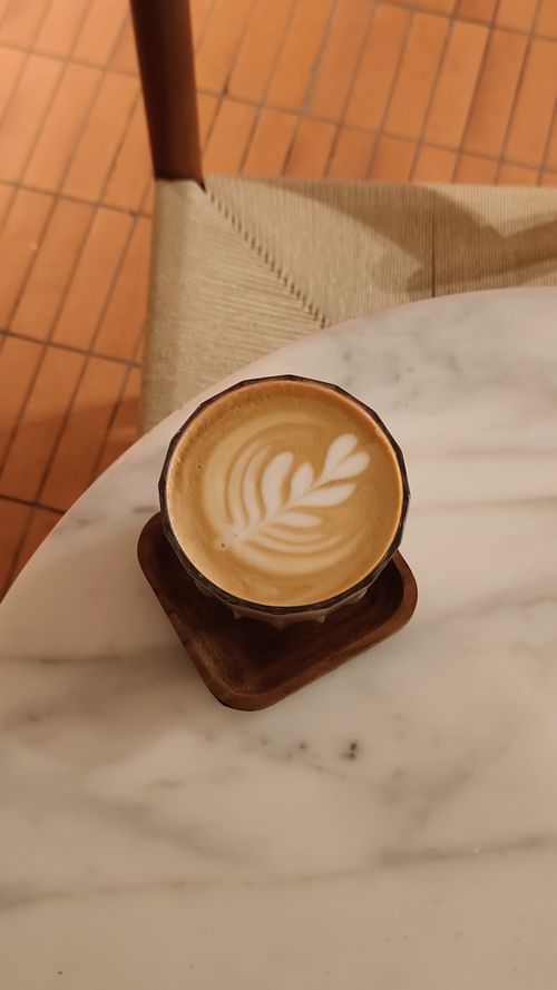 Free Elegant latte art in a cozy cafe setting with a marble table, perfect for warm moments. Stock Photo