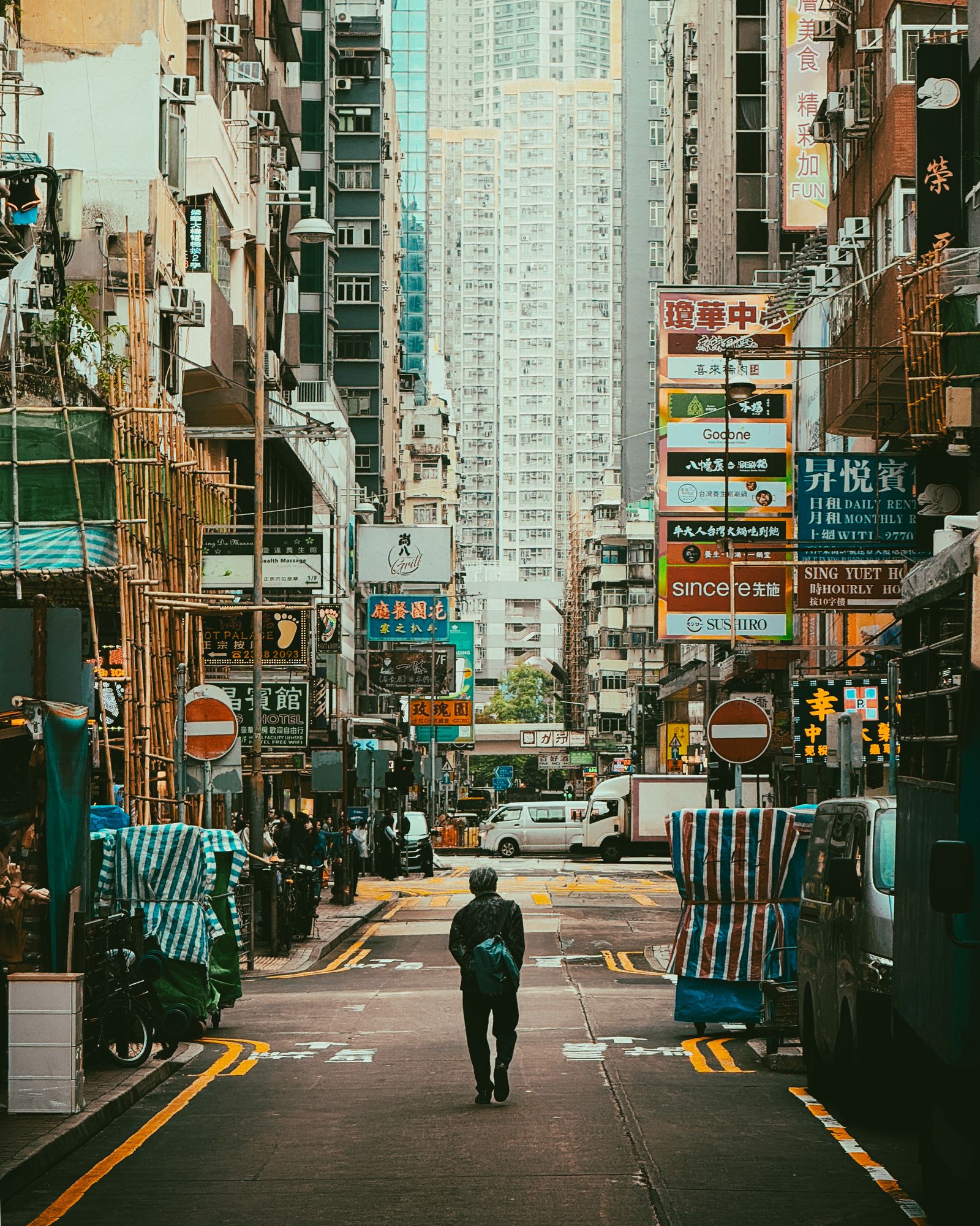 Hong Kong street lit by vibrant neon signs at night with urban life