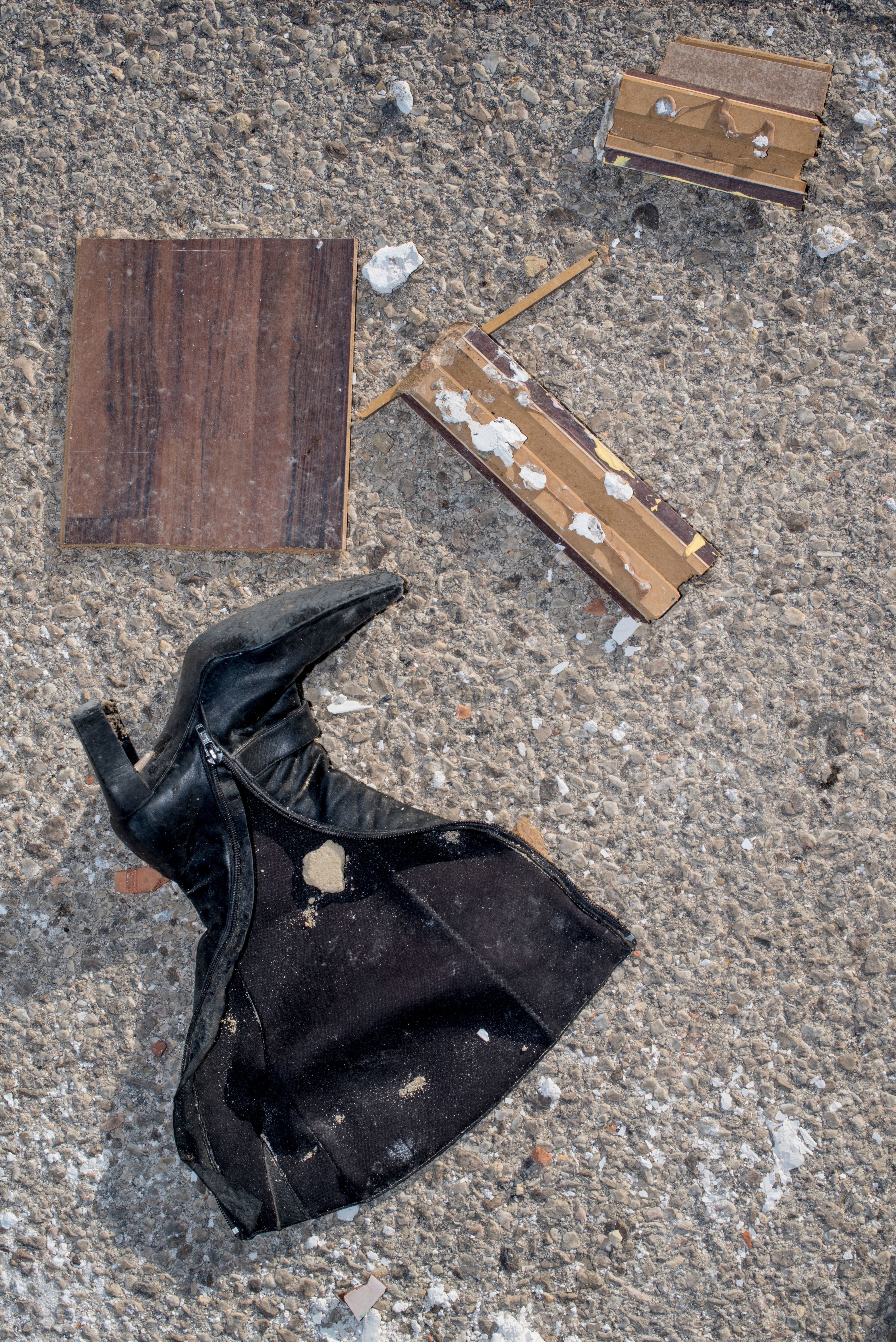 Discarded Boot and Debris on Concrete Surface · Free Stock Photo