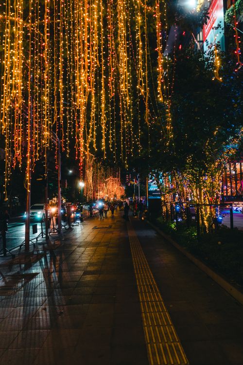 Free Vibrant street decorated with sparkling lights, capturing Bangkok's festive ambiance during nighttime. Stock Photo