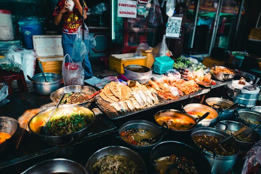 Authentic Thai street food market scene in Bangkok, showcasing diverse dishes.