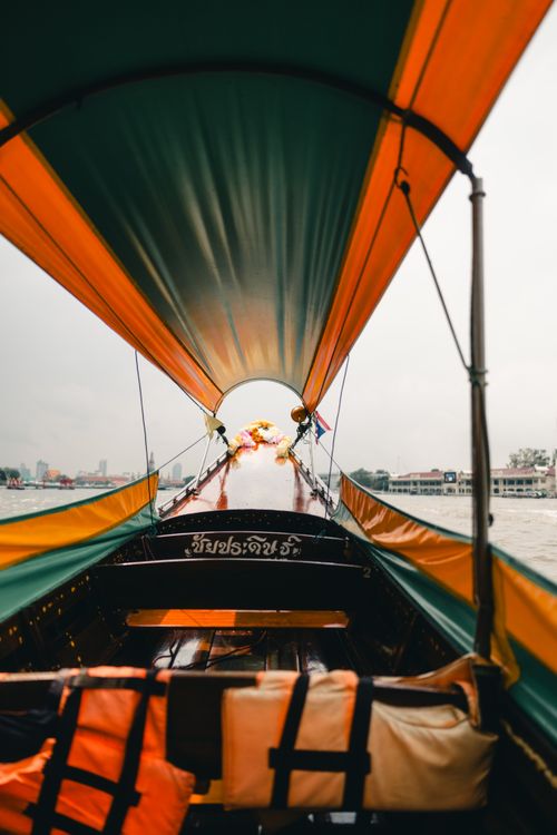Free Experience a scenic ride on a traditional Thai long-tail boat along the Chao Phraya River in Bangkok. Stock Photo