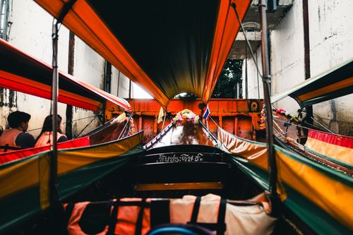 Free Vibrant longtail boat in a Bangkok canal offering a unique perspective of the city. Stock Photo