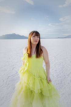 Elegant portrait of a woman in a yellow dress at the Utah Salt Flats.