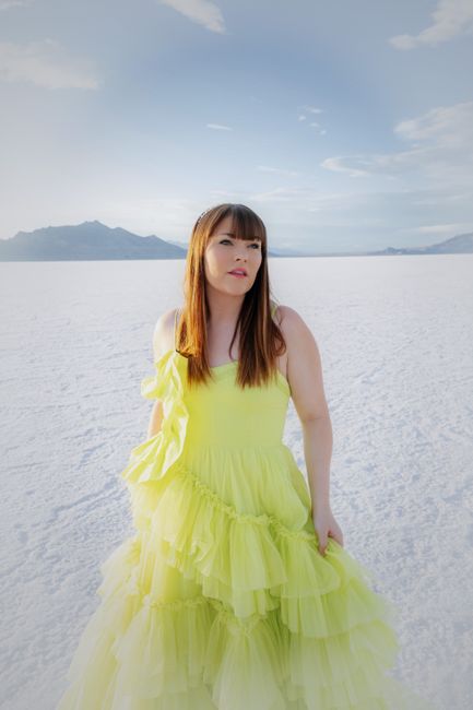 Elegant portrait of a woman in a yellow dress at the Utah Salt Flats.