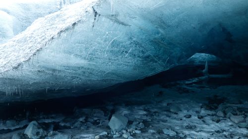 Free Explore the mesmerizing interior of an ice cave with stunning blue hues. Stock Photo