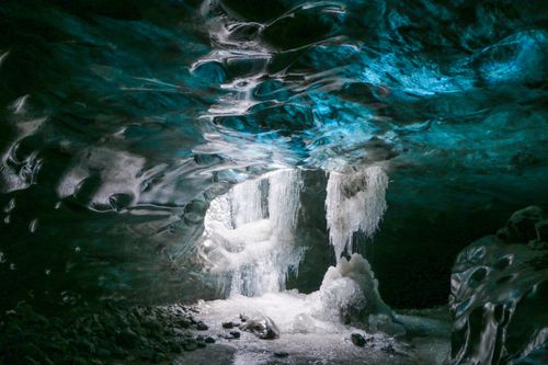 Free Explore the mesmerizing beauty of an ice cave with stunning icicles and a blue icy glow. Stock Photo