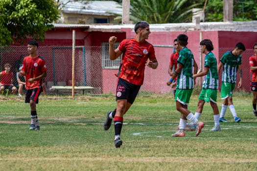Youth soccer players in action on a sunny day, showcasing team spirit and competition.