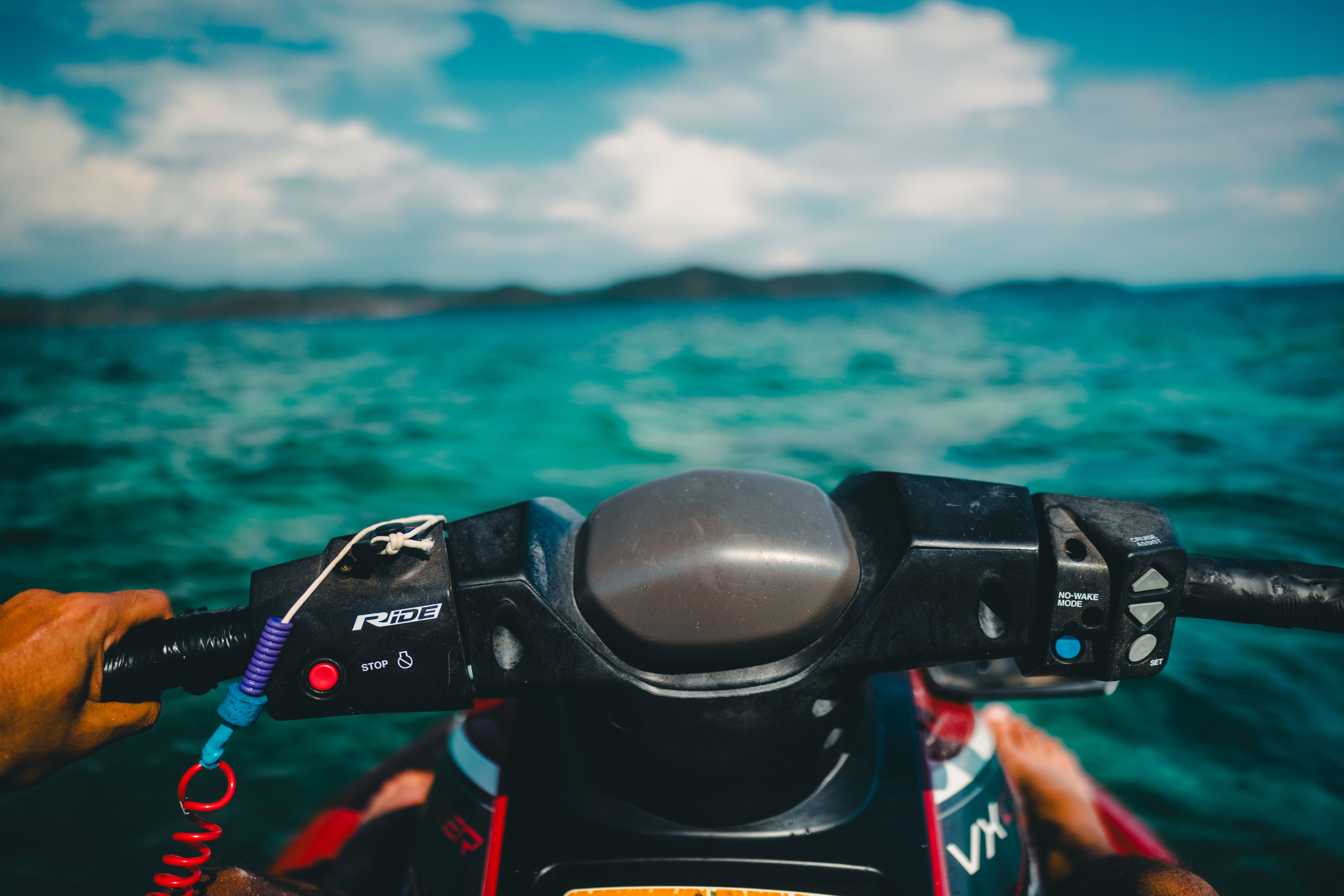 Experience the thrill of jet skiing across Phuket's azure seas with stunning island views.