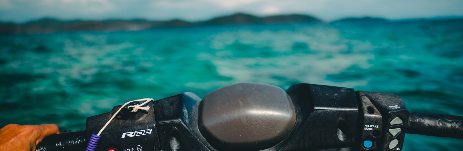 Experience the thrill of jet skiing across Phuket's azure seas with stunning island views.