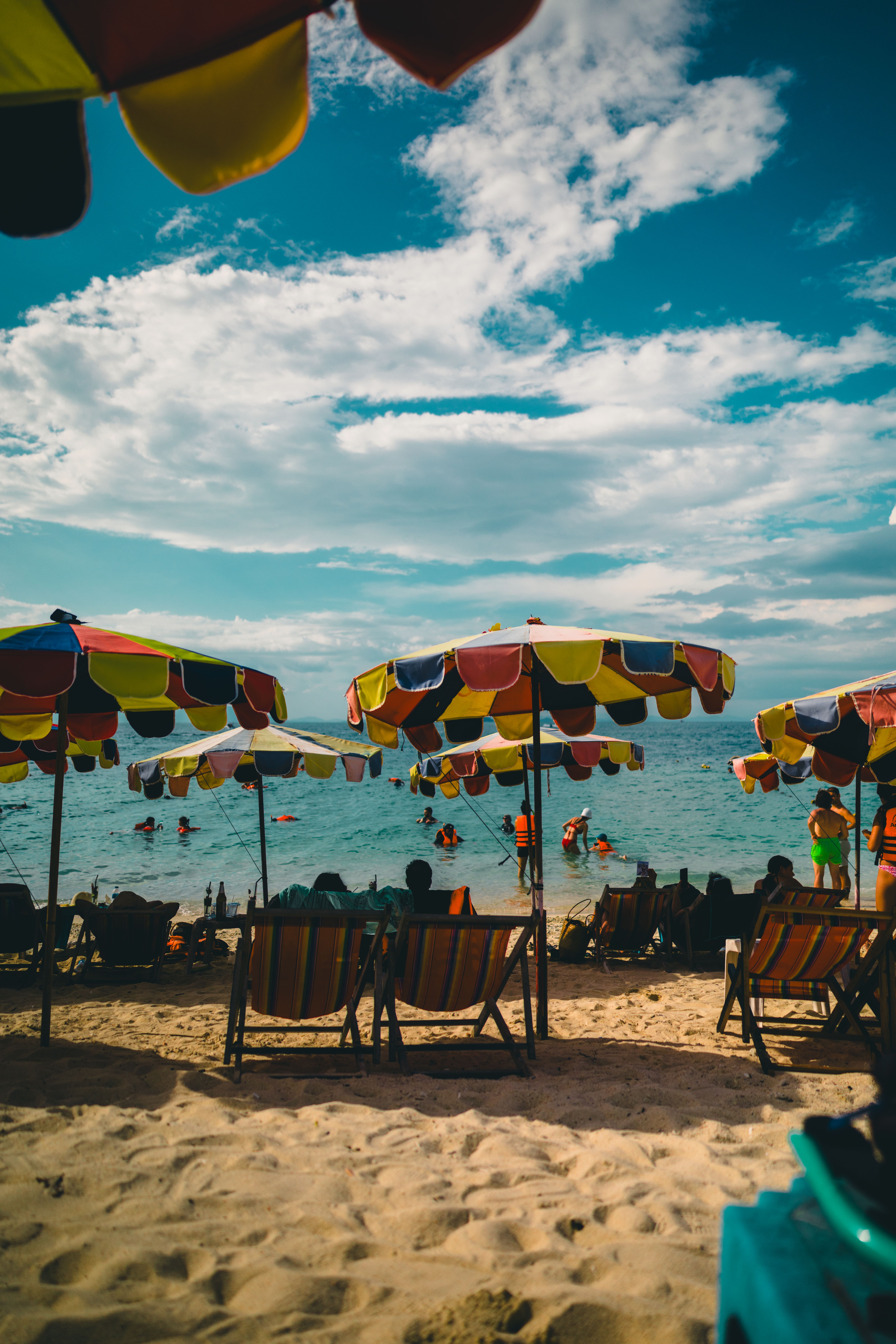 Phuket Patong Beach with longtail boats and beach umbrellas Thailand