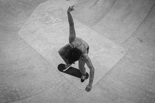 Free Skateboarder performing an aerial trick at a skatepark in Bali, captured in black and white. Stock Photo