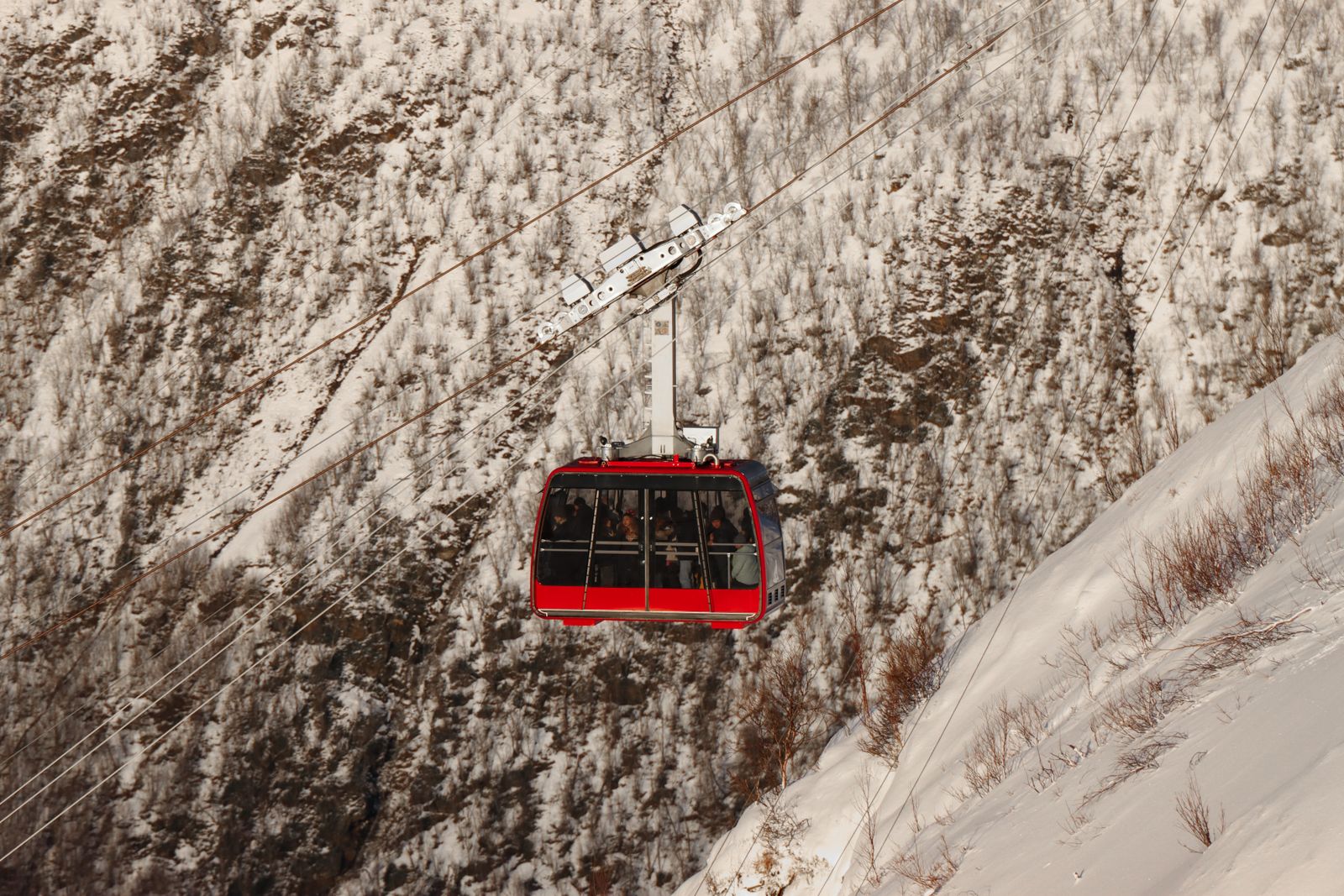 Tromsø Fjellheisen red cable car descending snowy mountain