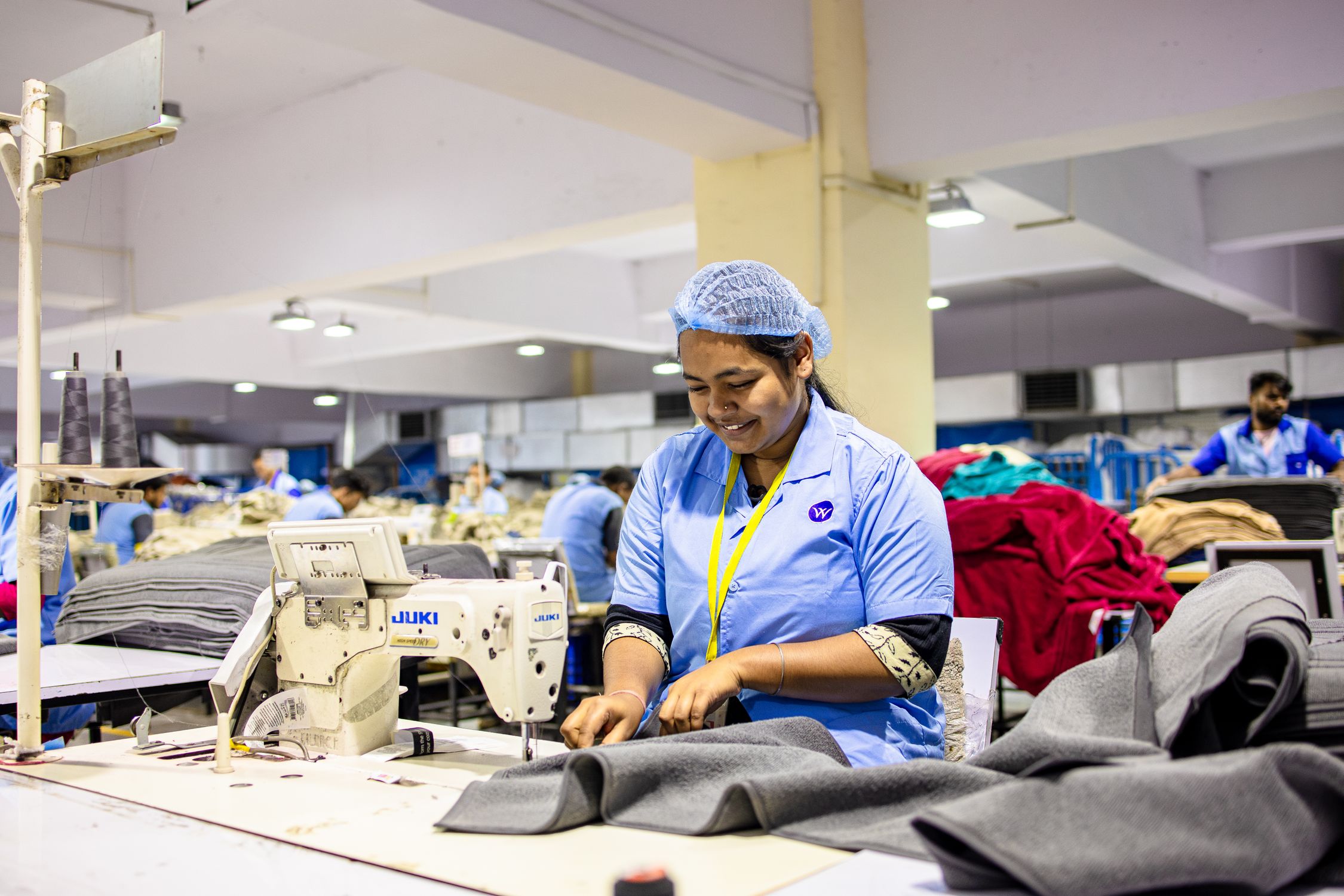 Female Textile Worker Sewing in Factory · Free Stock Photo