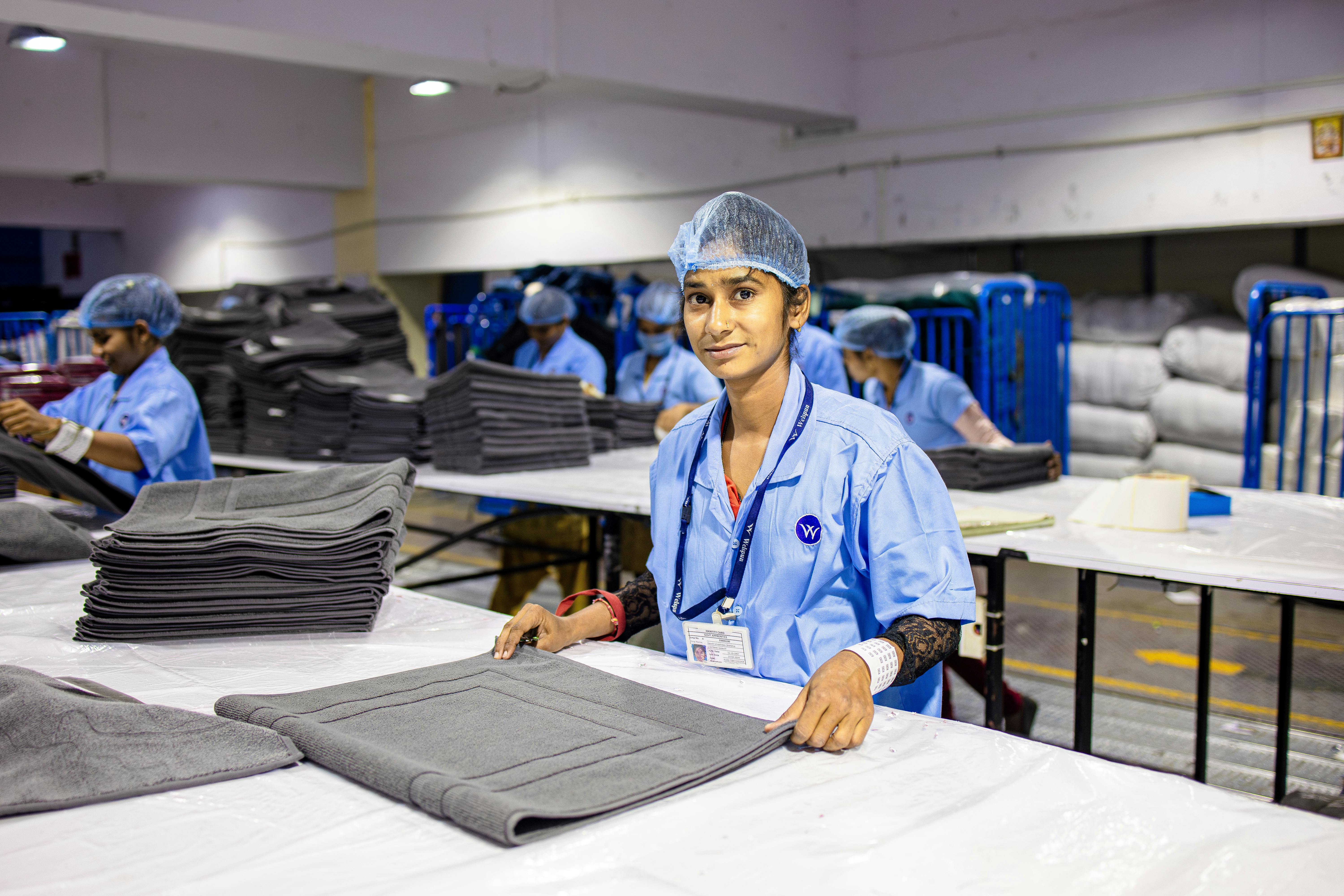Textile factory workers engaged in fabric processing with efficiency and focus.
