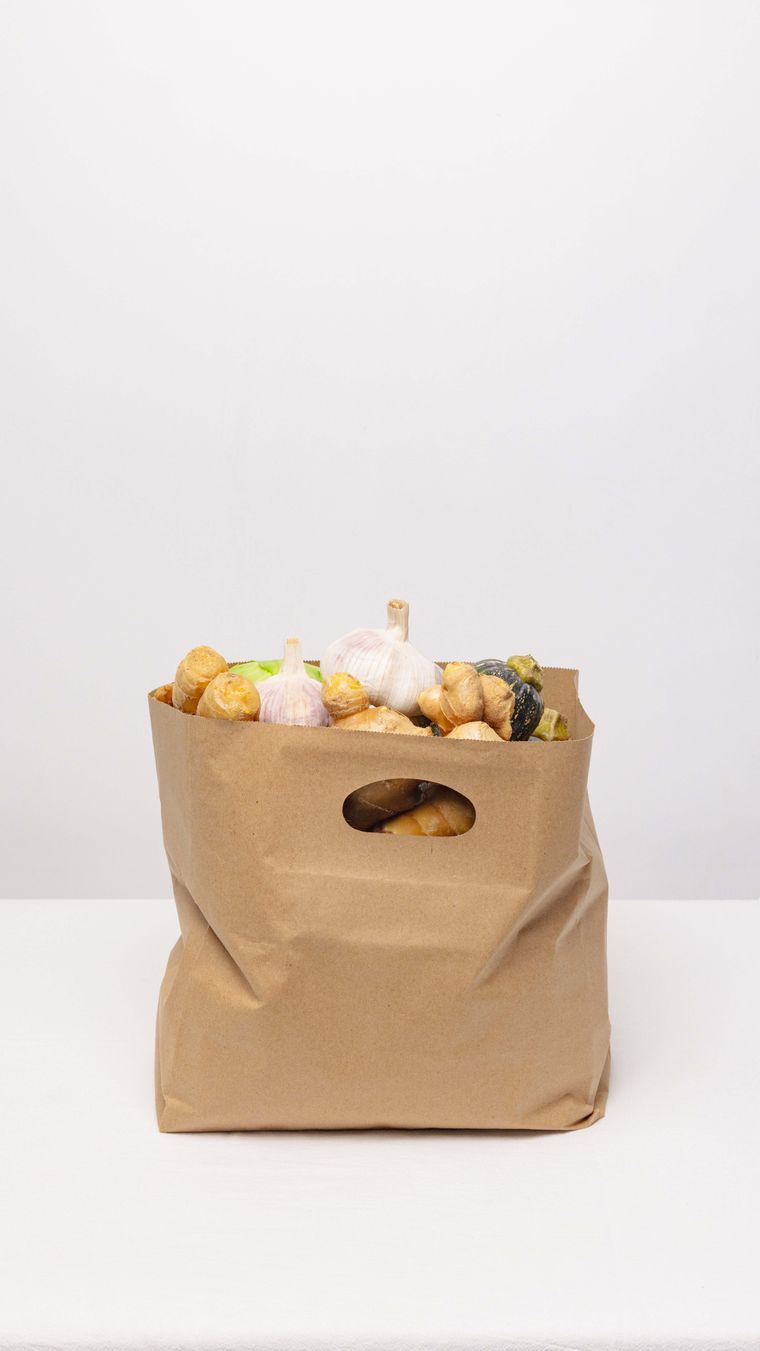 A kraft paper bag filled with fresh vegetables — photo by SU JI on Pexels
