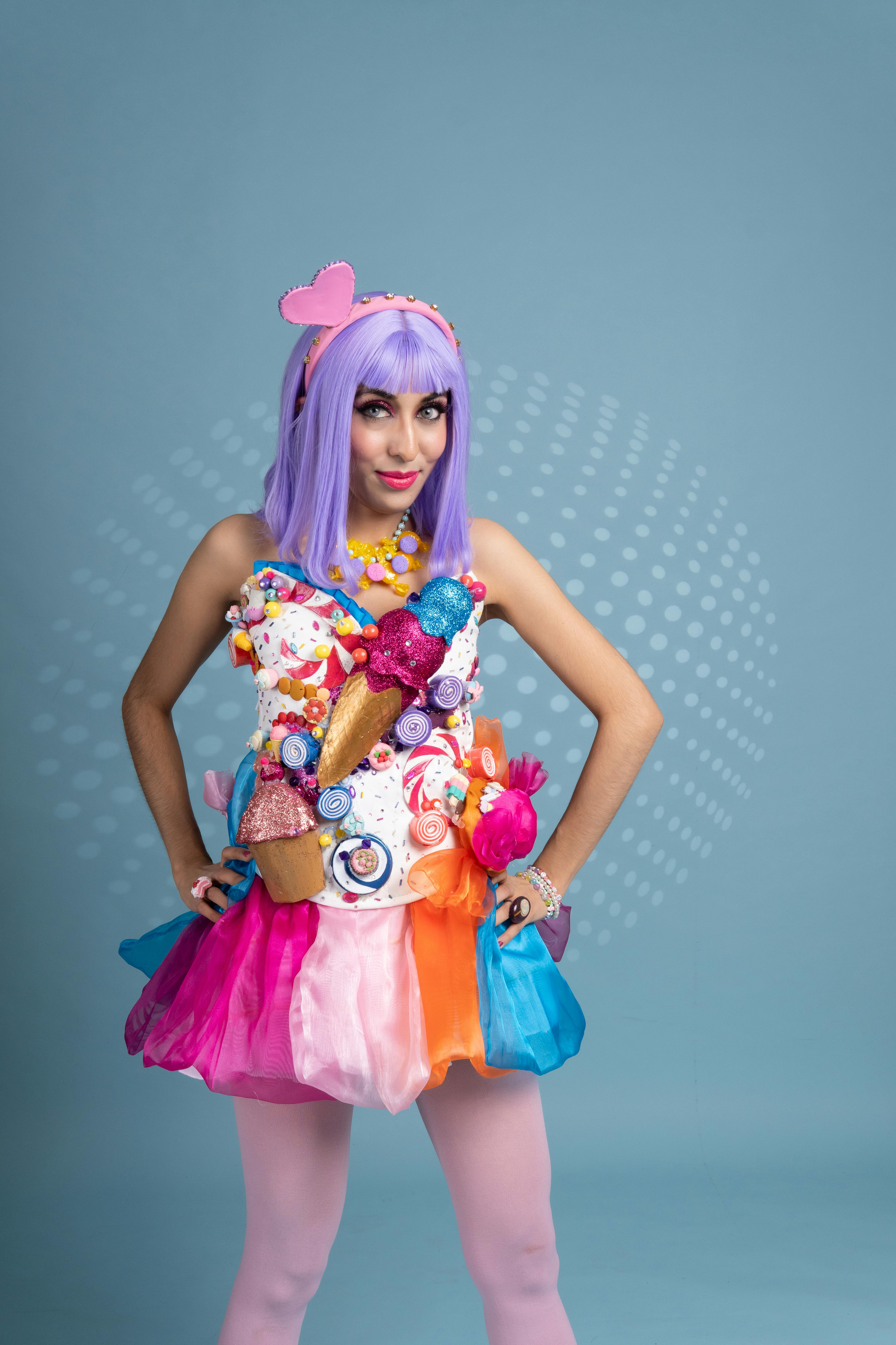 Colorful cosplay outfit featuring candy decorations and a playful purple wig.