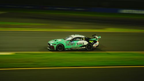 Free Captivating night shot of a speeding race car on the track. Stock Photo