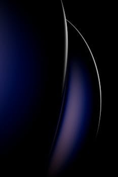 Sleek abstract art with curved dark blue and black patterns, perfect for modern decor.