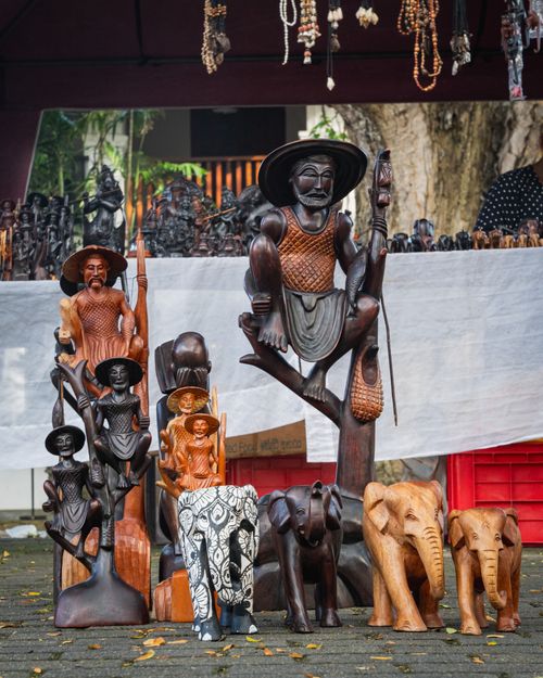 Free Intricate wooden sculptures displayed at a market in Galle, Sri Lanka. Perfect for cultural and artistic exploration. Stock Photo