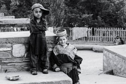 Boy Standing Beside Child Standing Beside Concrete Surface