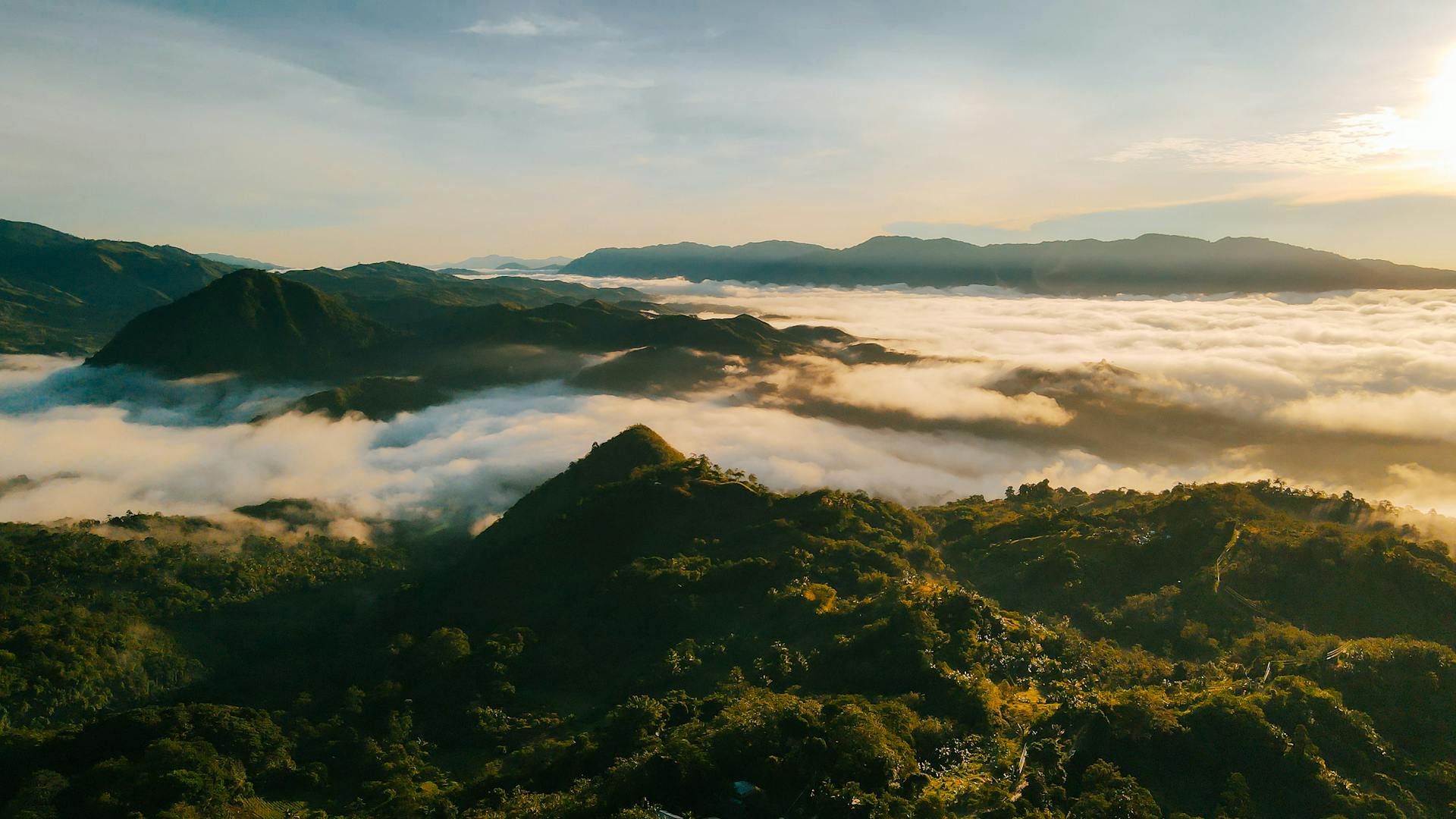 Breathtaking sunrise view over lush mountains and clouds in Davao City, Philippines