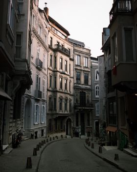 Charming narrow street lined with historic European buildings in soft evening light.