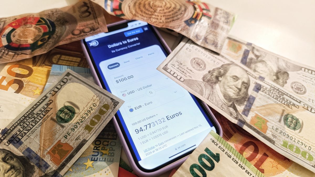 Person sending an international money transfer from a phone