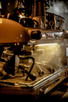 A close-up of a steaming espresso machine in a cozy Kermanshah cafe.