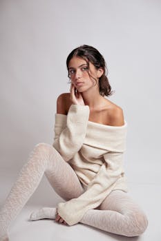 Elegant portrait of a woman in warm knitwear, embodying modern fashion style.