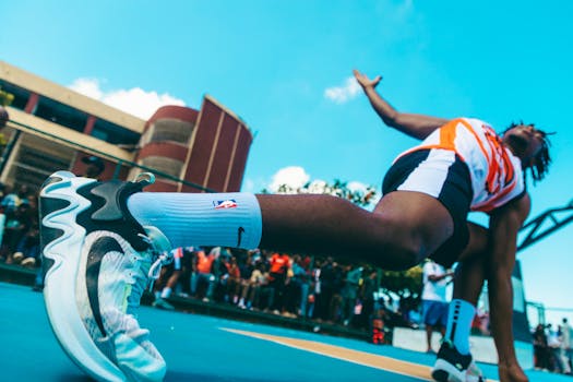 Vibrant capture of a basketball player in action on an outdoor Lagos court, showcasing speed and style.