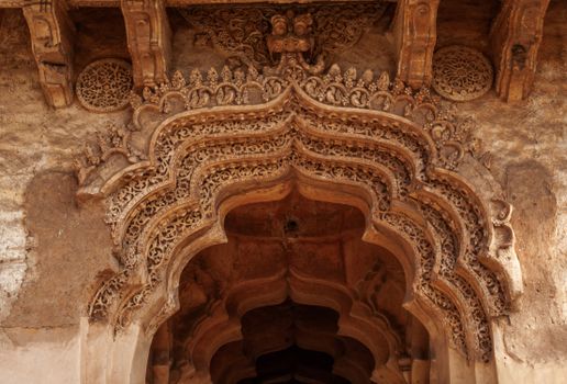 Detailed view of an ornate stone carving on a historical archway, showcasing traditional architecture.