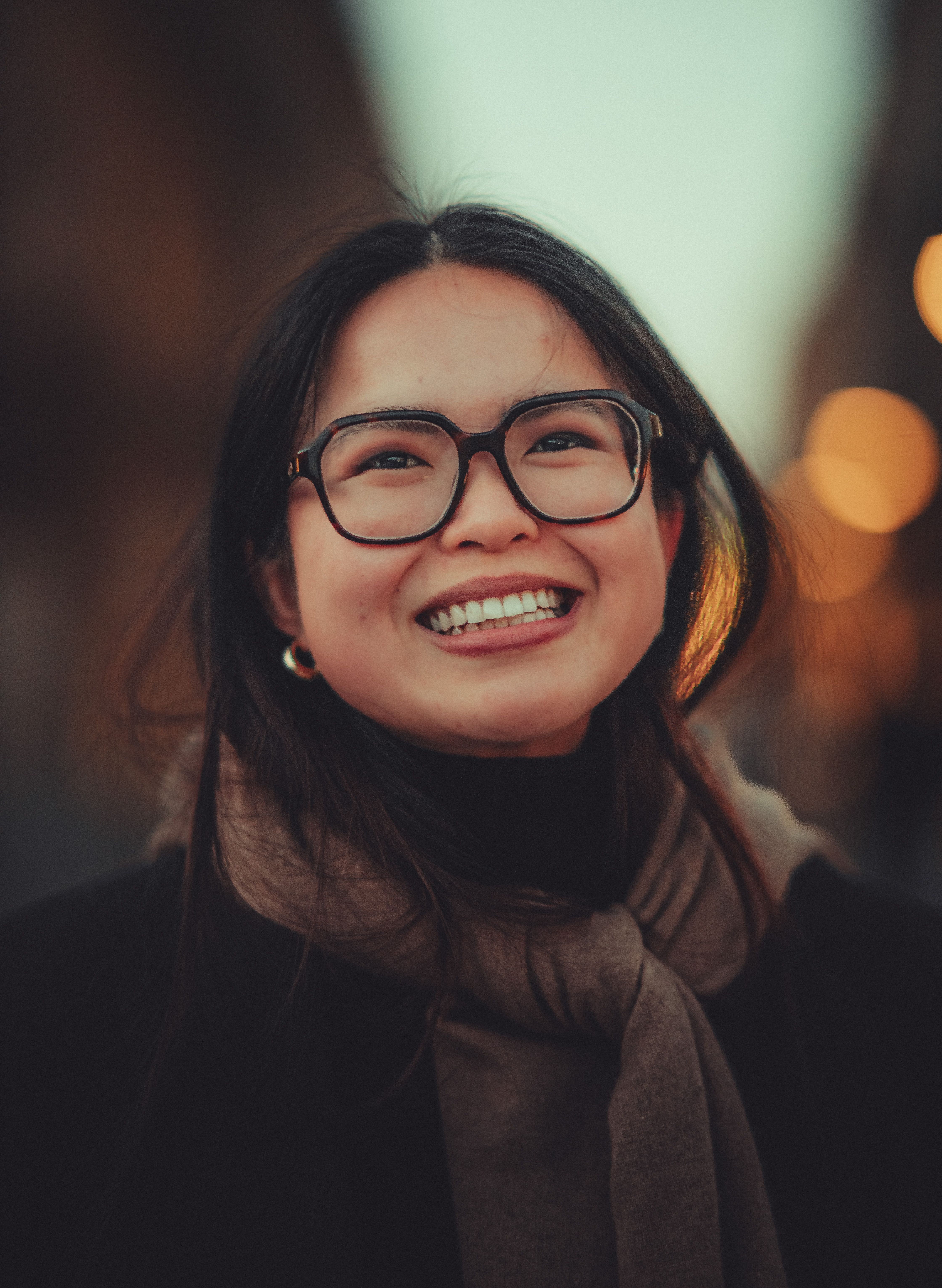 Smiling Woman in Urban Setting at Dusk · Free Stock Photo