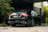 Luxury Black Car Parked in Tropical Setting