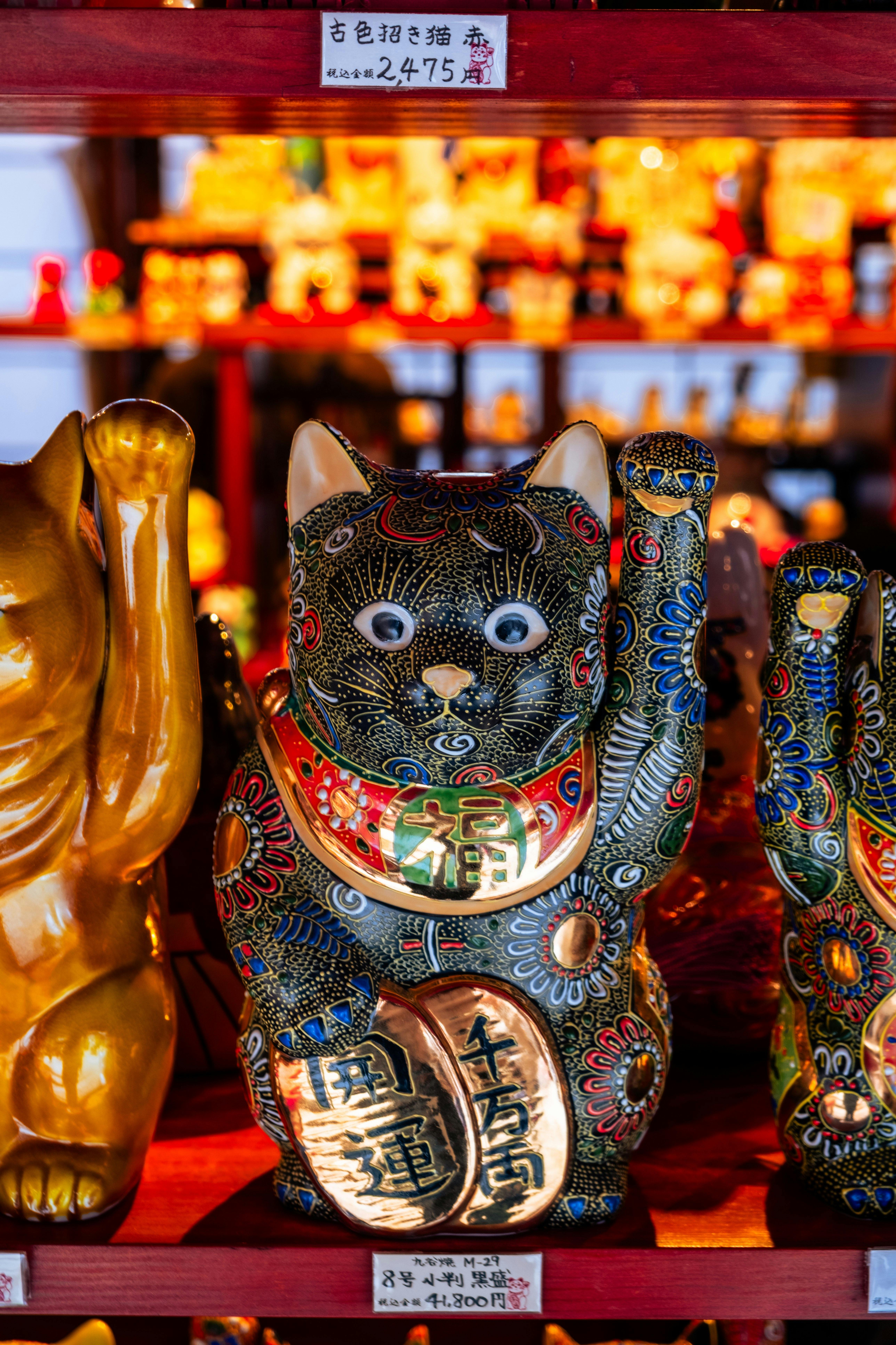 Vibrant Maneki-neko figurine in Ise, Japan shop, symbolizing luck and fortune.