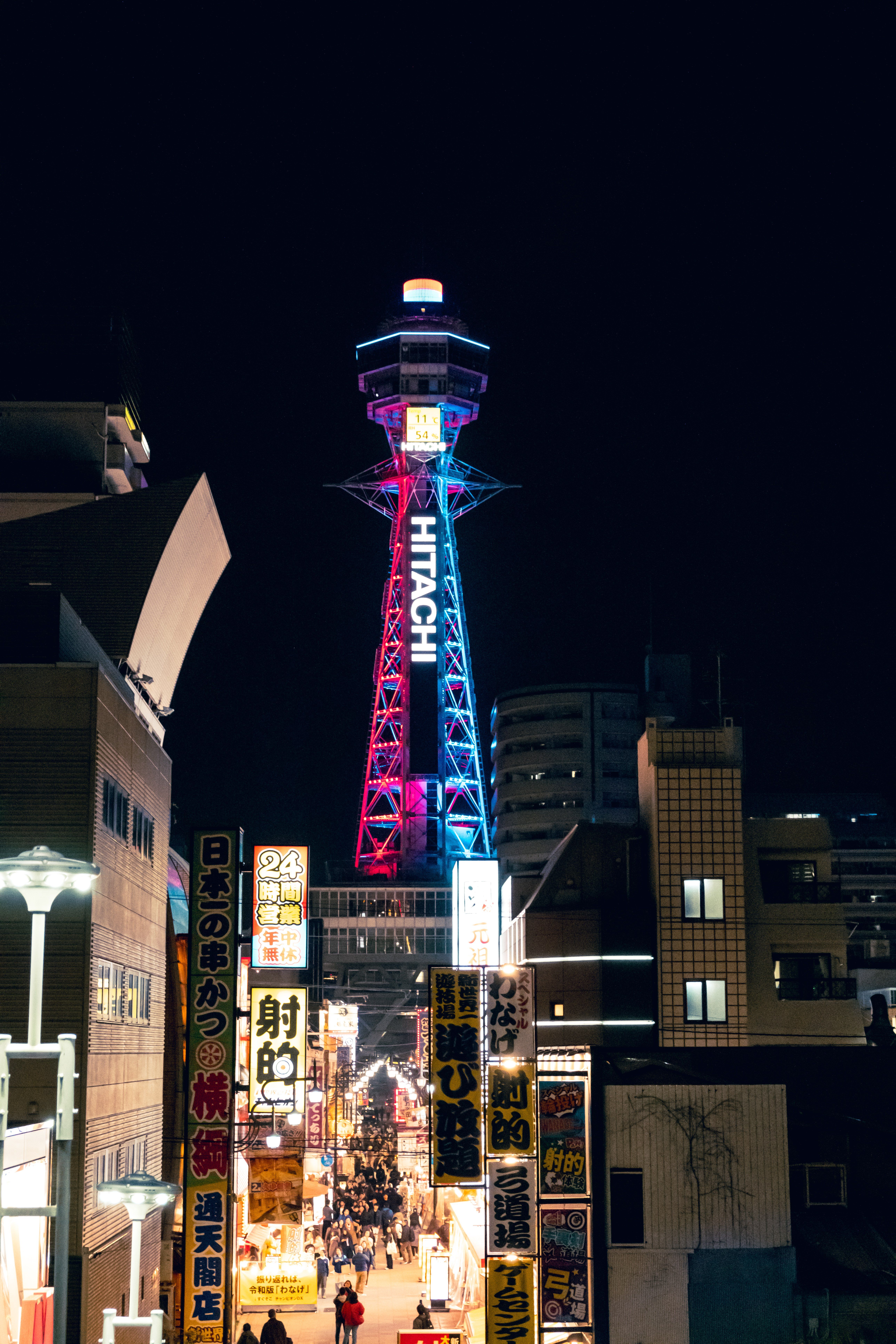 Tsutenkaku Tower lit up at night in Osaka Shinsekai district