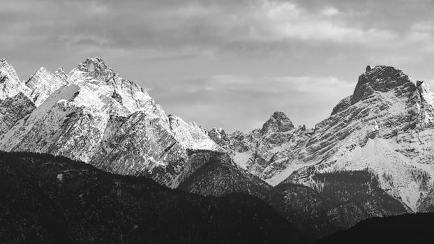 Dramatic black and white photo of the snow-capped Dolomites in Veneto, Italy.