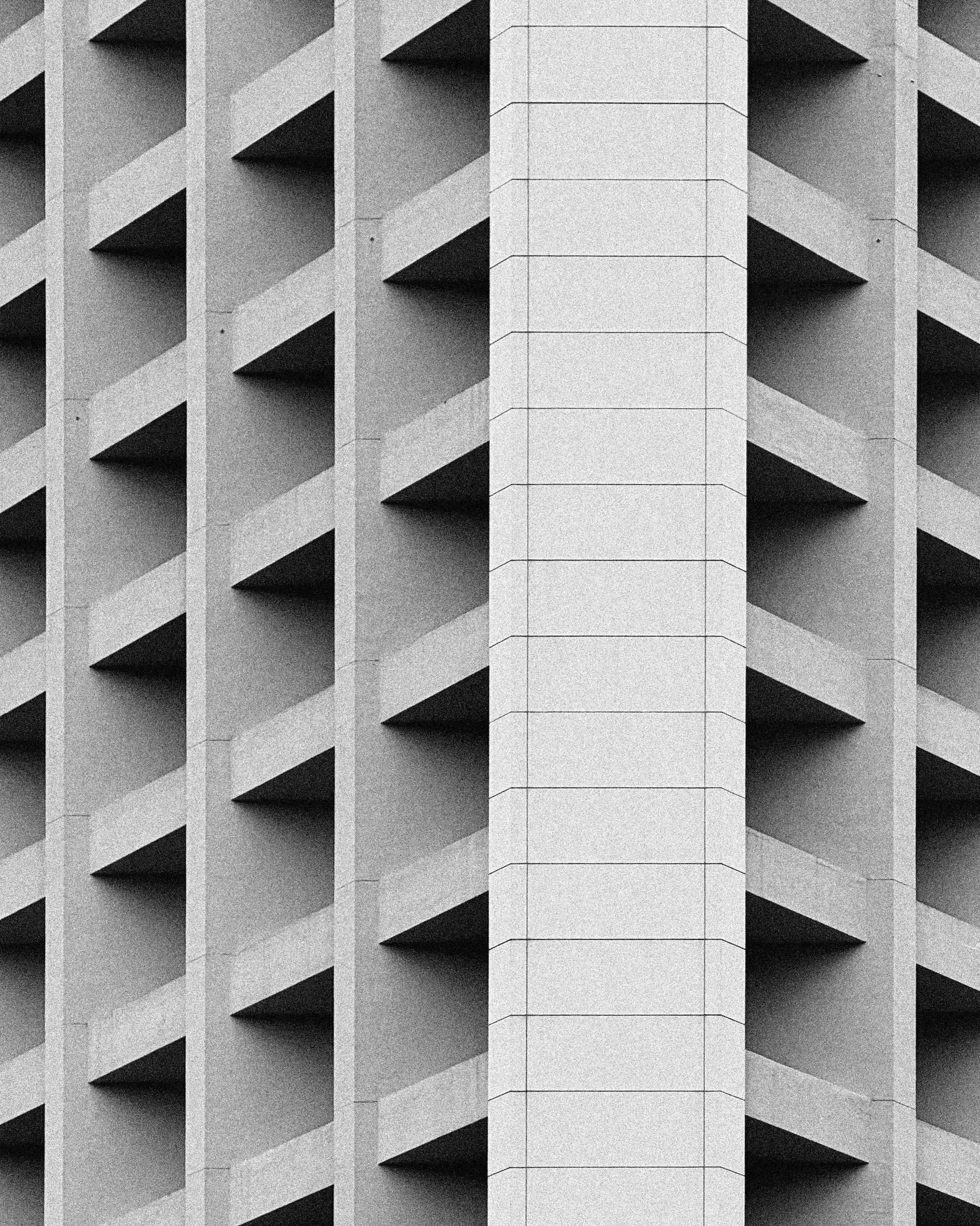 Black and white photo of a contemporary geometric building facade in Hong Kong.