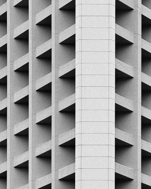 Black and white photo of a contemporary geometric building facade in Hong Kong.