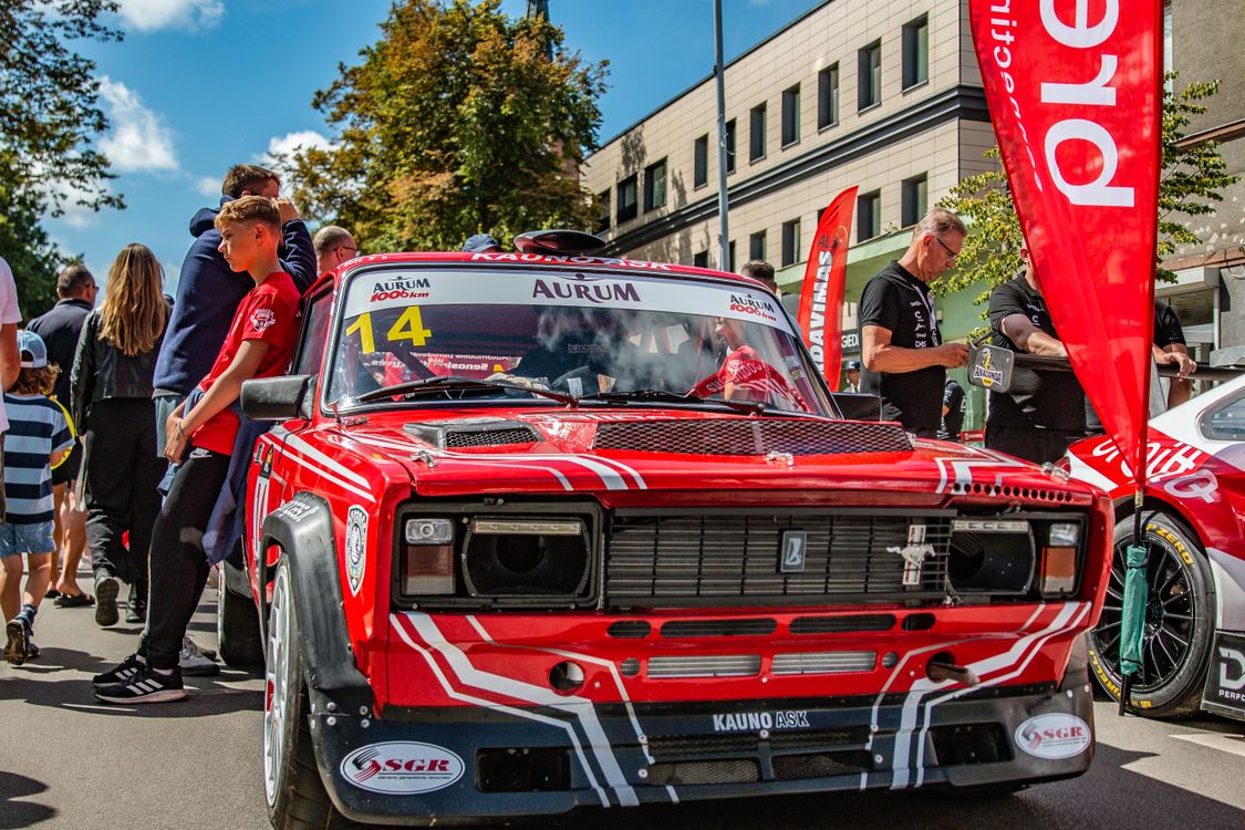 Vibrant Racing Event with Classic Red Car · Free Stock Photo