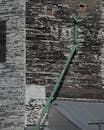 Weathered Grain Elevator with Green Pipe