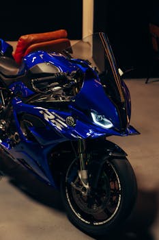 Close-up of a striking blue motorcycle parked indoors, highlighting its modern design.