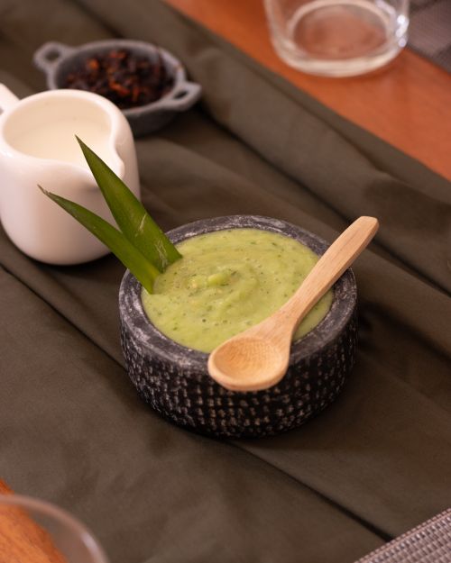 Free Fresh guacamole in a stone bowl with a wooden spoon, perfect for authentic Mexican dining. Stock Photo